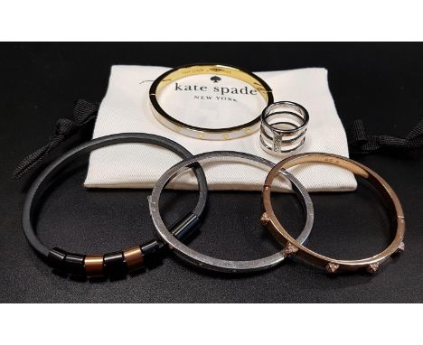 SELECTION OF FASHION JEWELLERYcomprising a Kate Spade white enamel decorated hinged bangle, a Swarovski crystal bangle, a Gue