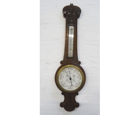 ADMIRAL FITZROY'S ANEROID BAROMETERin a carved oak case with a thermometer above a circular dial, 91cm high 