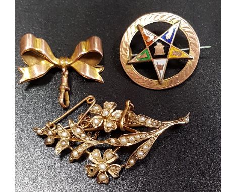 THREE NINE CARAT GOLD BROOCHEScomprising a seed pearl set spray brooch, an enamel decorated Eastern star brooch, and a small 