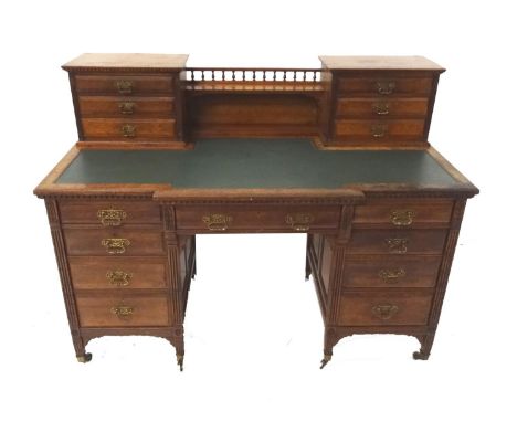 EDWARDIAN MAHOGANY BREAKFRONT KNEE HOLE DESKwith a central gallery and shelf flanked by two sections each of three panelled d