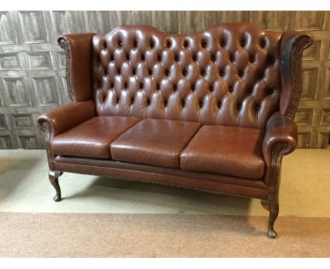 THREE PIECE WING BACK SUITE, of Queen Anne design, upholstered in button back brown leather, with detachable seat cushions, o