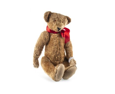 STEIFF TEDDY BEAR, with glass eyes, lacking button to ear, with red ribbon, with replacement felt pads, approximately 60cm lo