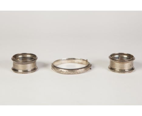 PAIR SILVER NAPKIN RINGS with bead edge and engine turned, Chester 1944 and a HOLLOW SILVER HINGED BANGLE bright cut engraved