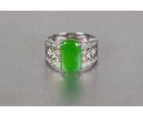 CHINESE WHITE GOLD COLOURED METAL BROAD RING, set with a rounded oblong green jade, the broad fancy pierced shoulders each se