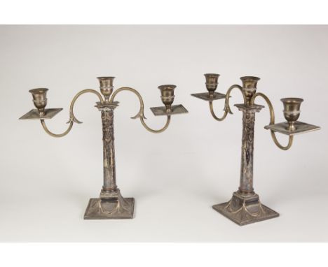 A PAIR OF EARLY TWENTIETH CENTURY ELECTROPLATED  'ADAM REVIVAL' WEIGHTED CANDLESTICKS, of removable twin branch triple light 