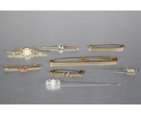 15ct GOLD BAR BROOCH, collet set with a centre oval pale blue stone, 2.6gms; A STICK PIN in the form of a German dagger bayon