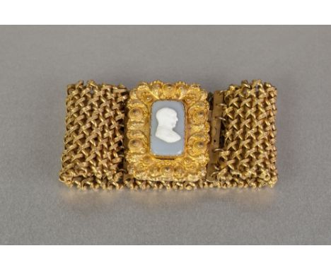 WILLIAM IV STYLE GILDED PINCHBECK WOVEN CUFF BRACELET, set with green and white glass oblong portrait cameo in the large embo
