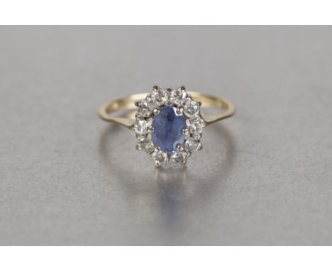 18ct GOLD CLUSTER RING, set with an oval Ceylon sapphire and surround of ten diamonds, ring size 'K' 