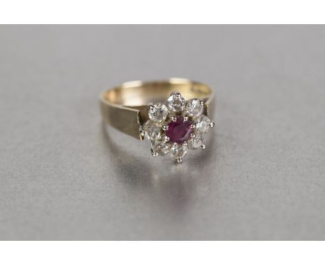 18cT GOLD RUBY AND DIAMOND DAISY CLUSTER RING, set with a circular centre ruby approx 5mm diameter, and surround of eight dia