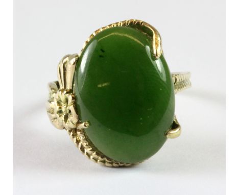 A 10ct yellow gold (worn stamp 10ct) ring set with cabochon cut jade (L.5).