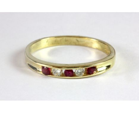 An 18ct yellow gold ruby and diamond half eternity ring (O.5).