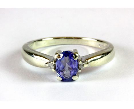 A 9ct white gold tanzanite and diamond set ring (J.5).