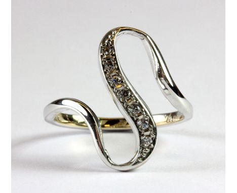 A 14ct white gold diamond set wave shaped ring (O).