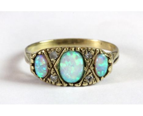 A 9ct yellow gold opal and diamond set ring (Q.5).