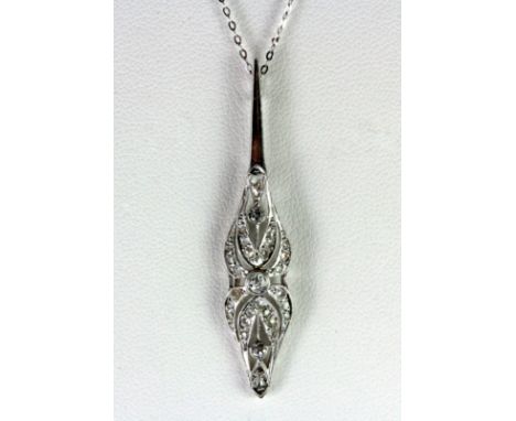 An Art Deco white metal (tested platinum and white gold) diamond set pendant on a 9ct white gold chain on an antique box, L. 