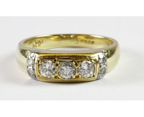A 14ct yellow gold ring set with three brilliant cut diamonds and diamond set shoulders (N).