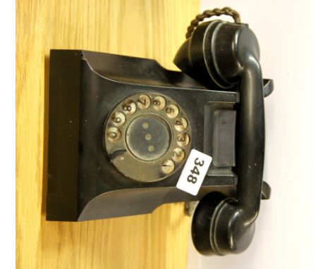 A vintage black telephone.