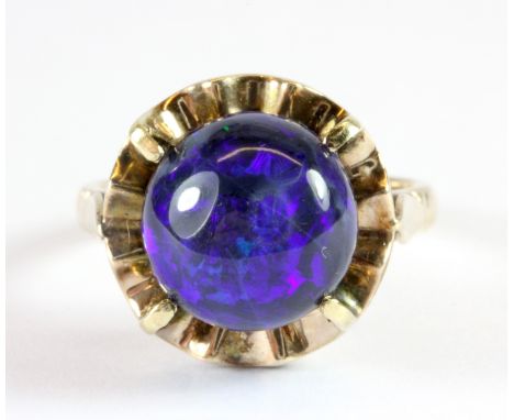 An 18ct yellow gold (stamped 18k) ring set with a cabochon cut blue opal (Q.5).