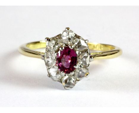 An 8ct yellow gold (stamped 8ct) ruby and diamond cluster ring (K).