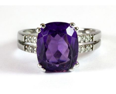 A 9ct white gold amethyst set ring with diamond set shoulders (L.5).