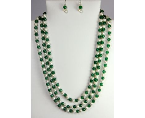 A triple row pearl and jade necklace on a white metal clasp with a matching pair of earrings.