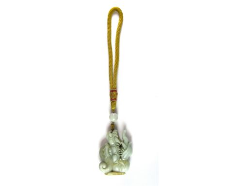 A superb Chinese carved jade dragon amulet. W.7cms with silk carrying handle.
