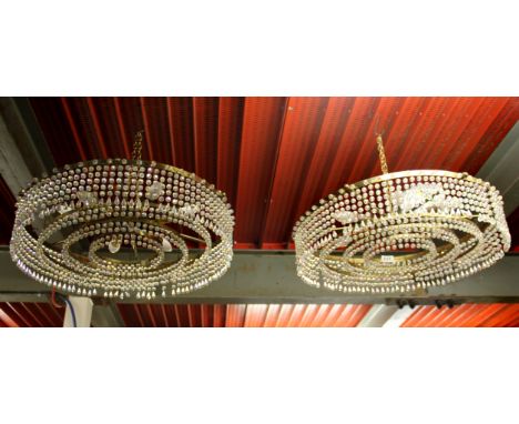 A pair of circular 1970's crystal and gilt chandelier light fittings, Dia. 60cm.