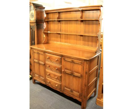 An Ercol oak dresser. W. 145cms H.170cms.