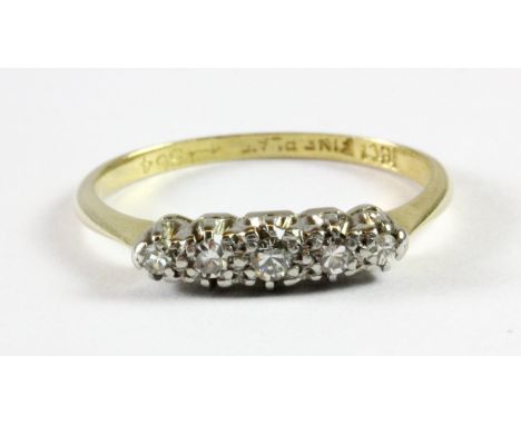 An 18ct gold and platinum (stamped 18ct and plat) five diamond set ring (N.5).