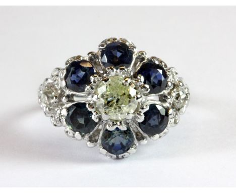 A stunning white metal (tested 18ct gold) diamond and sapphire cluster ring with diamond set shoulders (O.5).