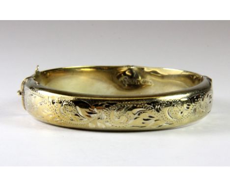 A hallmarked silver gilt bangle, L. 7cm.