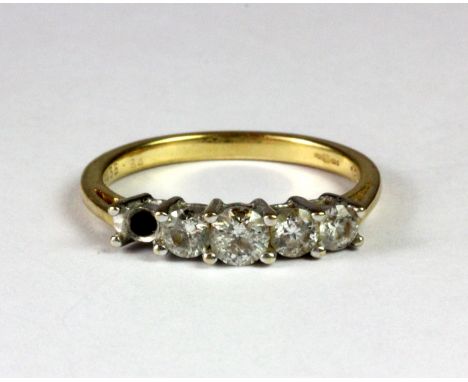 An 18ct yellow and white gold five diamond set ring (one diamond missing) (O.5).