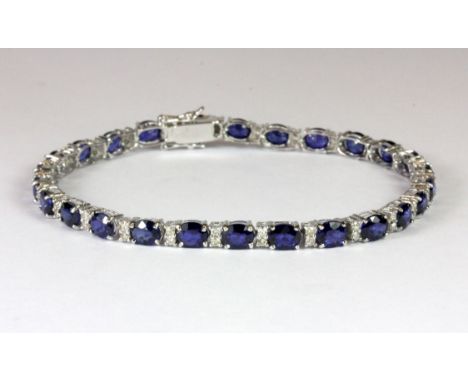 A lovely 18ct white gold (stamped 750) sapphire and diamond tennis bracelet, L. 19cm.