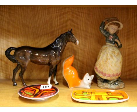 A Beswick horse, two Poole Pottery dishes and two other items.