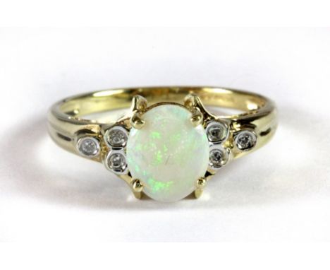 A 9ct yellow gold ring set with a cabochon cut opal and diamond set shoulders (S.5).