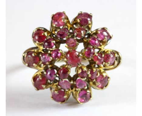 A yellow metal (tested minimum 9ct gold) ruby cluster ring (O.5).