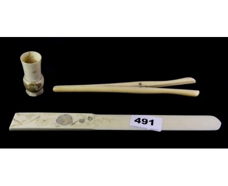 A 19th century mother of pearl inlaid Chinese ivory paper knife, engraved dice shaker and glove stretchers.