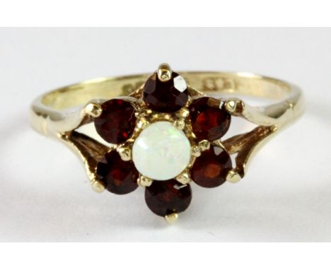 A 9ct yellow gold opal and garnet cluster ring (M.5).