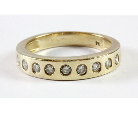 A 9ct yellow gold diamond set half eternity ring (O).