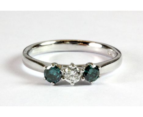 A platinum ring set with a brilliant cut diamond flanked by fancy blue brilliant cut diamonds (N).