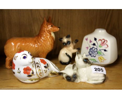 A Beswick dog, Crown Derby Seal, Poole pottery vase and two cat figures.