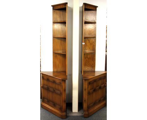 A pair of 1970's Ercol oak corner cabinets, H. 196cm.