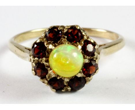 A 9ct yellow gold opal and garnet cluster ring (N.5).