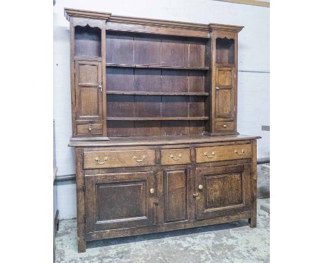 DRESSER, George III oak, the rack with open shelves and two small cupboards above spice drawers on a base with three drawers 