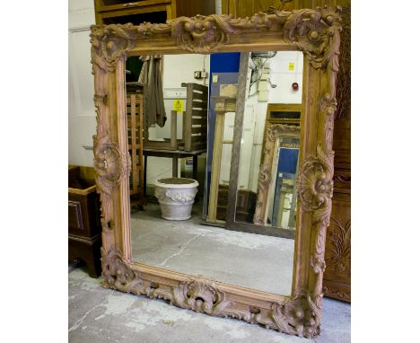 WALL MIRROR, vintage carved pine with broad rosette and scroll centred frame, 163cm x 140cm.