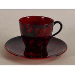 Royal Doulton Flambe coffee can & saucer decorated in the prunus design, c1920.