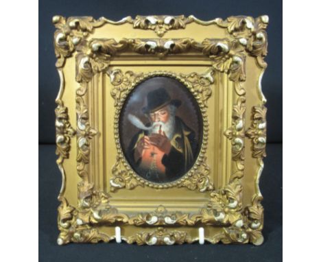 OVAL PORTRAIT MINIATURE painted on porcelain panel, a gentleman lighting his pipe in overcoat and hat. 9 x 7cm approx. Foliat