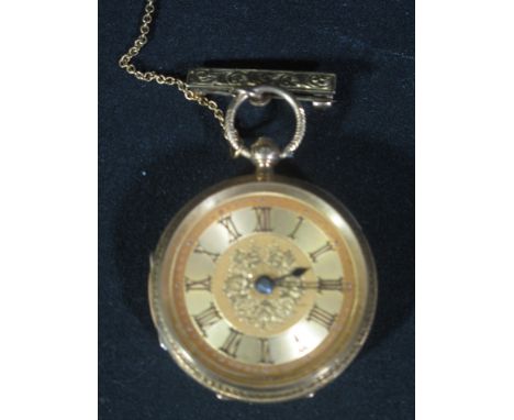 18CT GOLD FANCY KEY WIND OPEN FACED FOB WATCH having foliate engraved case and engine turned face with Roman numerals. 4cm di