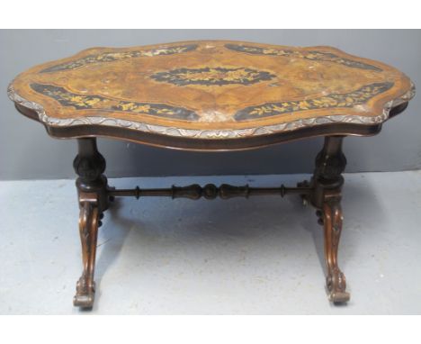 VICTORIAN MARQUETRY INLAID WALNUT SERPENTINE SHAPED CENTRE TABLE, the moulded edged top with ebonised foliate bands and centr