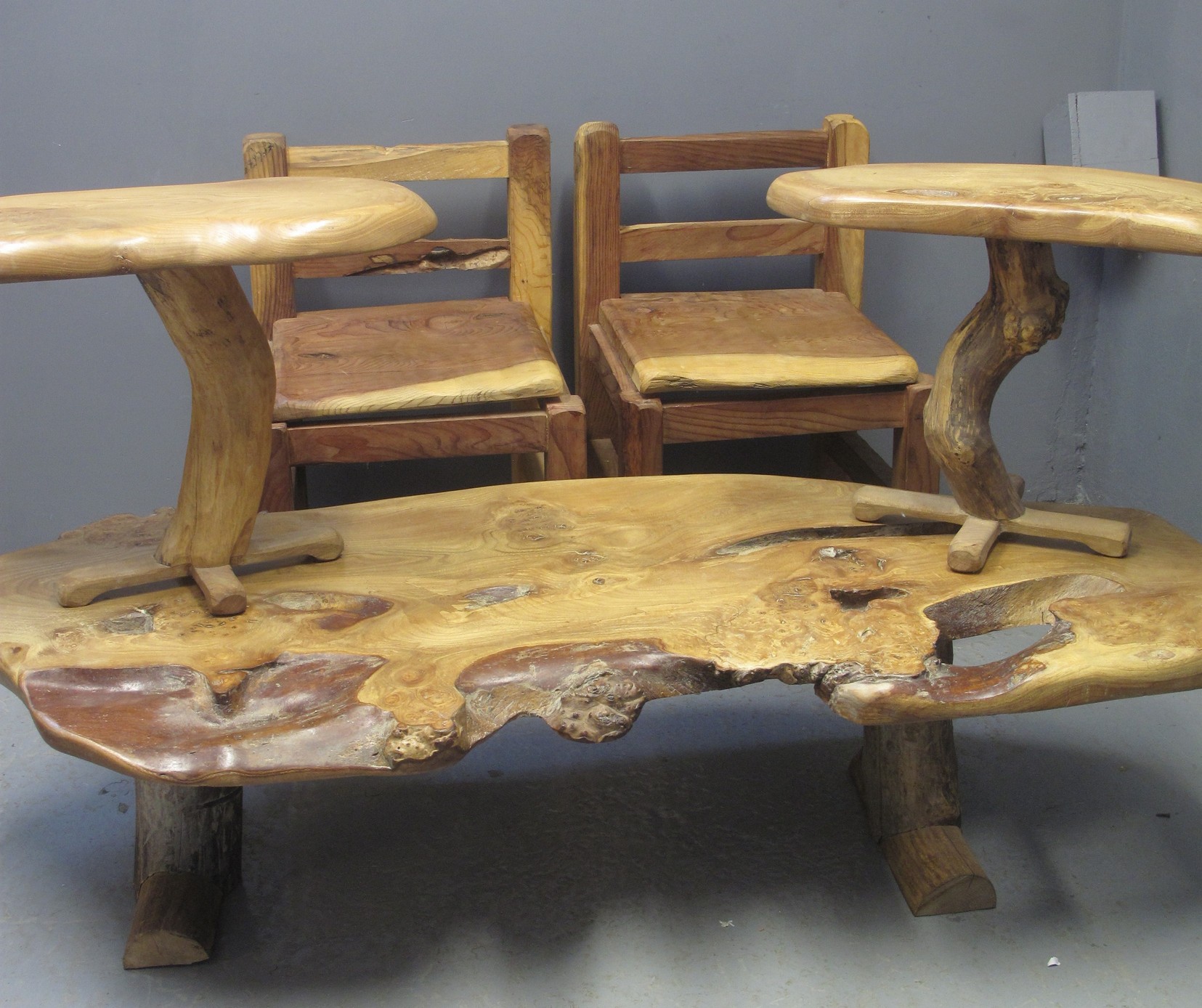 AN UNUSUAL SUITE OF RUSTIC HEAVILY CONSTRUCTED GIANT REDWOOD FURNITURE